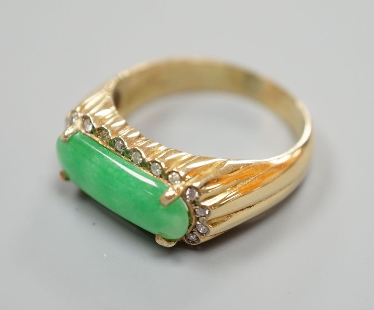 A yellow metal, jadeite and diamond set ovoid dress ring, size T, gross 6.6 grams.